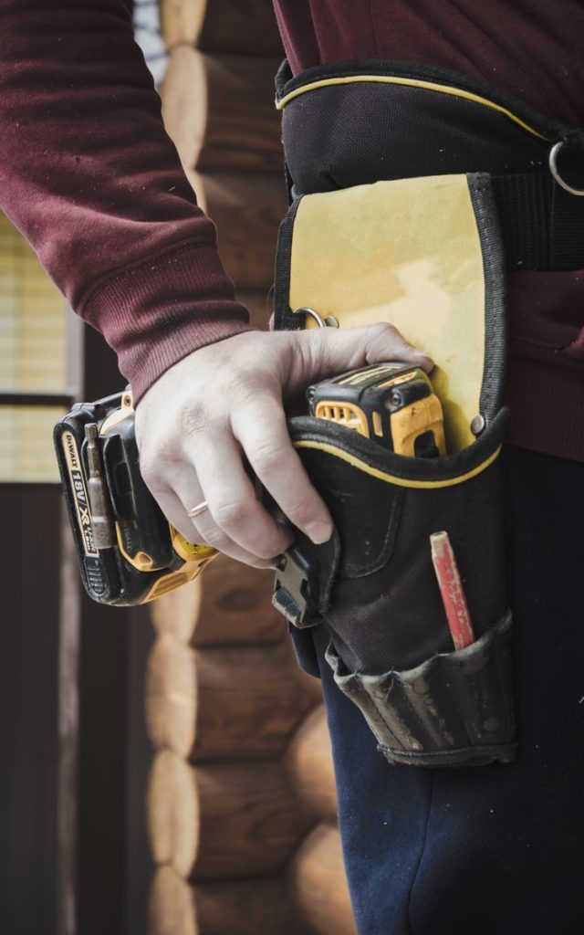 person holding black and yellow nike gloves